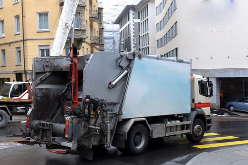 Operative using PPE while sorting commercial waste