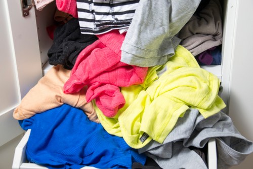 Workers wearing PPE checking waste containers